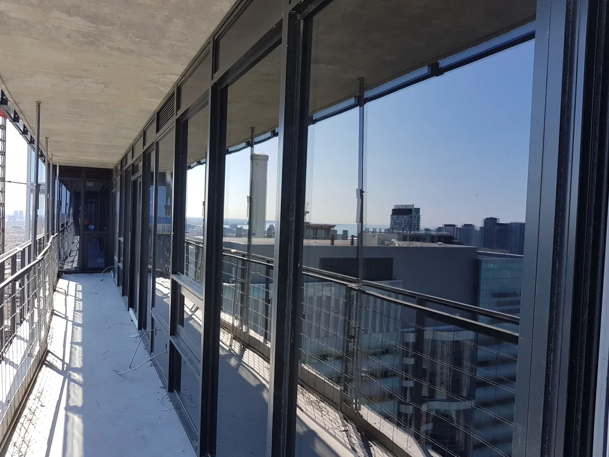 Window wall assembly at a high-rise balcony during construction