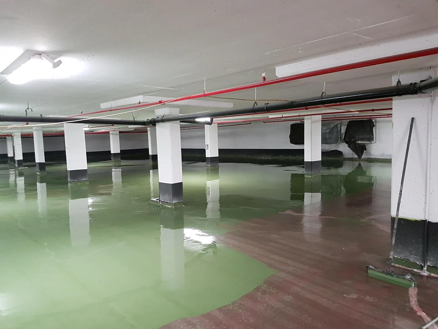 Green traffic-bearing waterproofing coating applied to a parking garage floor