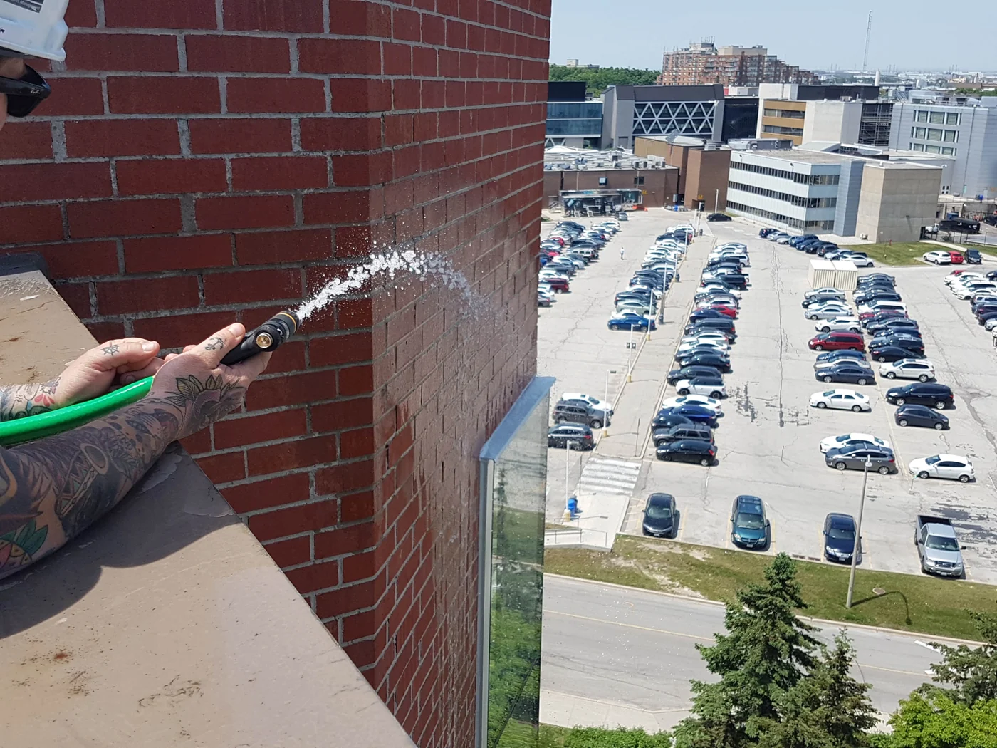 Water sprayed onto exterior brick masonry during a water penetration investigation